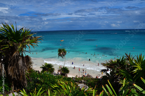 Turquoise waters of the Caribbean Sea on the picturesque beach with palms of Tulum in Yucatan, Mexico