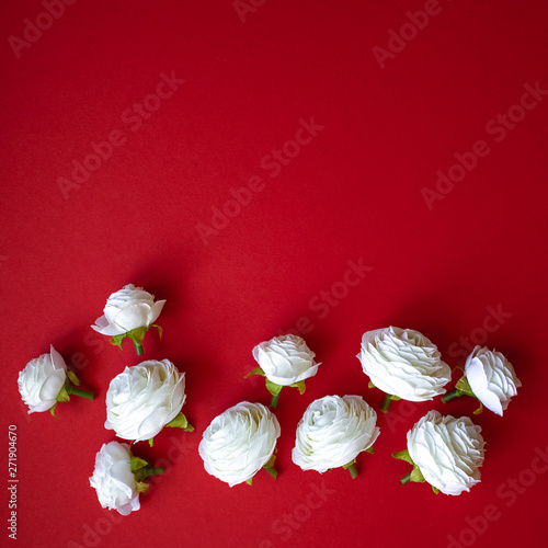 Abstract composition of spring flowers on red background.