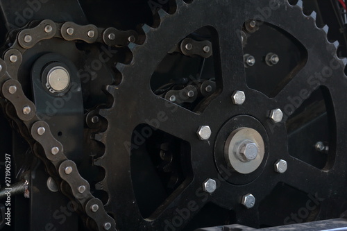 Transmission agricultural machinery. Sprockets, chain drives and springs are visible. Close-up.