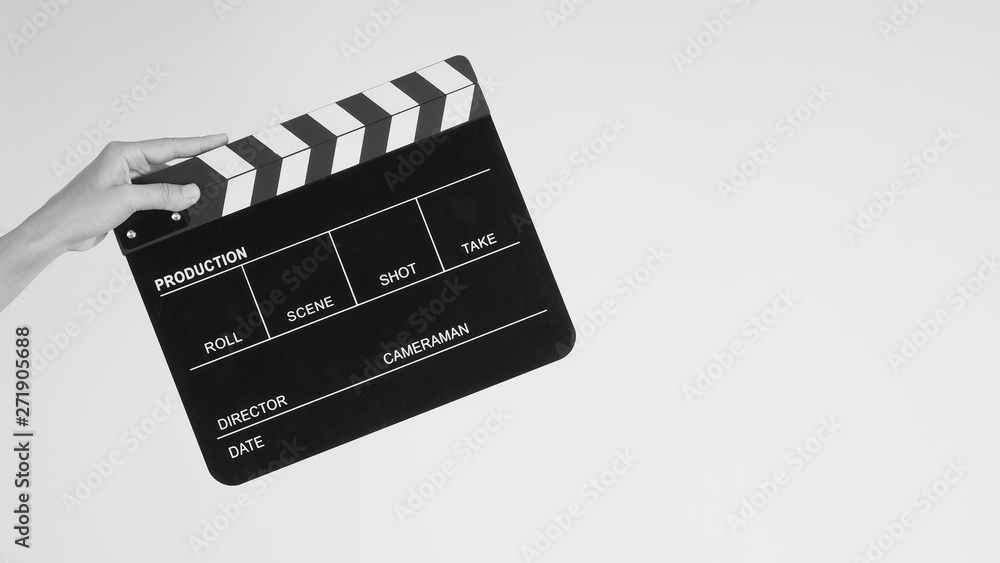 Hands is holding black Clapperboard or movie slate. it use in video production ,film, cinema industry on white background.