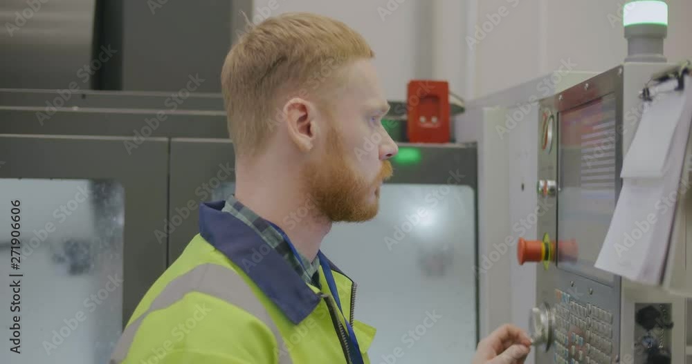 Factory worker operating machine Factory worker operating machine
