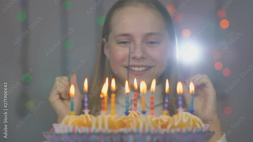 Teen girl blows out candles on cake cakes on her birthday. Teen girl blows out candles on cake cakes on her birthday.