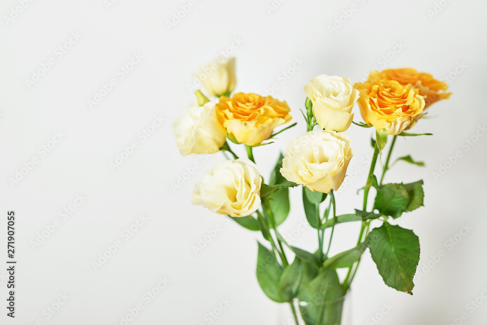 Yellow Roses for Mother's Day on a white wooden background.