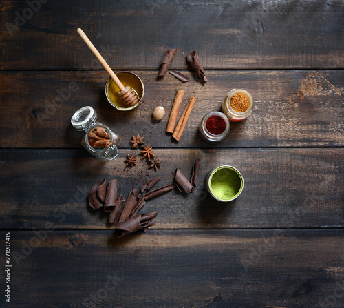 Top view spices, cinamon, matcha, safron, honey with wooden background