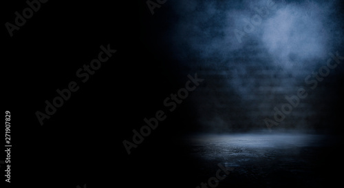 Dark empty scene, blue neon searchlight light, wet asphalt, smoke, night view, rays. Empty black studio room. Dark background. Abstract dark empty studio room texture. Product showcase spotlight back