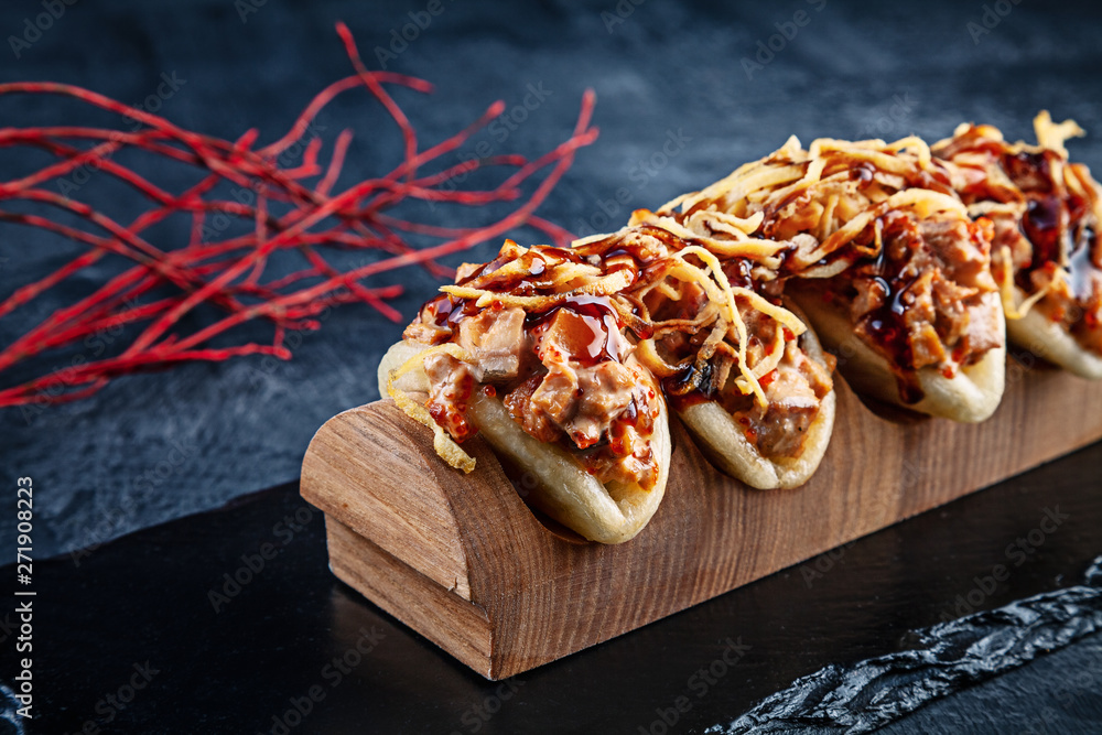 Close up on Gua bao, steamed buns with eel. Seafood Bao served with tasty topping on dark