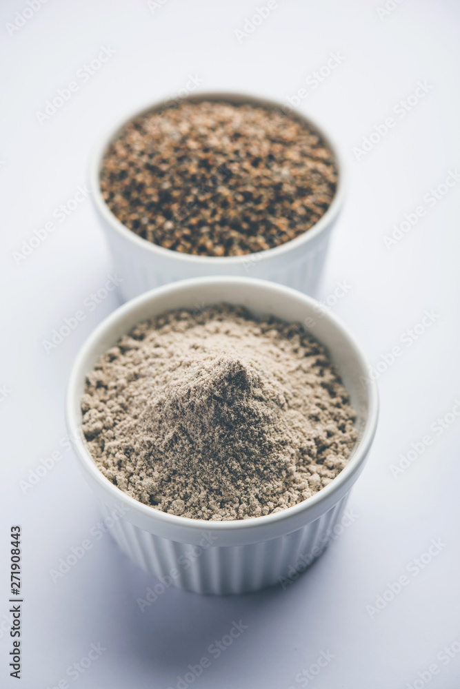 Bajra (pearl millet) / sorghum grains with it's flour or powder in a bowl, selective focus Bajra (pearl millet) / sorghum grains with it's flour or powder in a bowl, selective focus