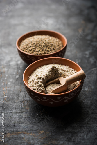 Fototapeta Naklejka Na Ścianę i Meble -  Bajra (pearl millet) / sorghum grains with it's flour or powder in a bowl, selective focus