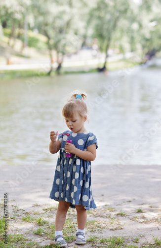 Adorable little girl blowing bubble
