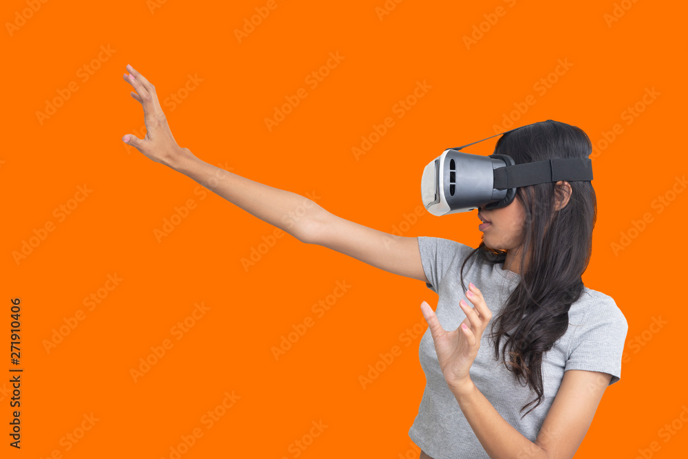 Girl try to catch sometiong while playing multimedia game with virtual reality glasses. Girl try to catch sometiong while playing multimedia game with virtual reality glasses.