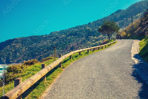 Mountain road along the sea on a sunny day