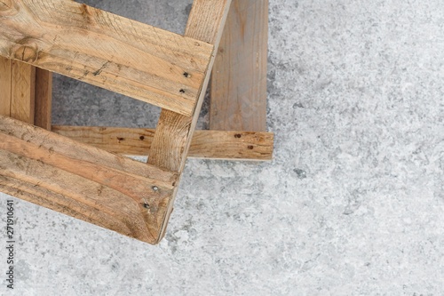 Wooden pallets stand on a concrete pier. Copy space. Texture. Blur. Background