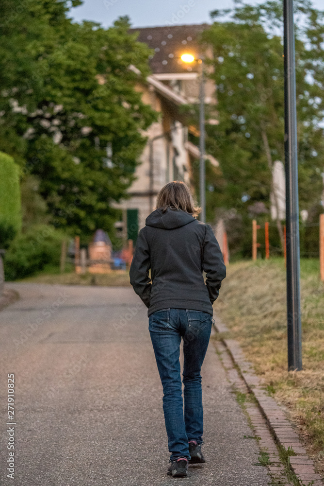 woman walking up a hill in a urban area