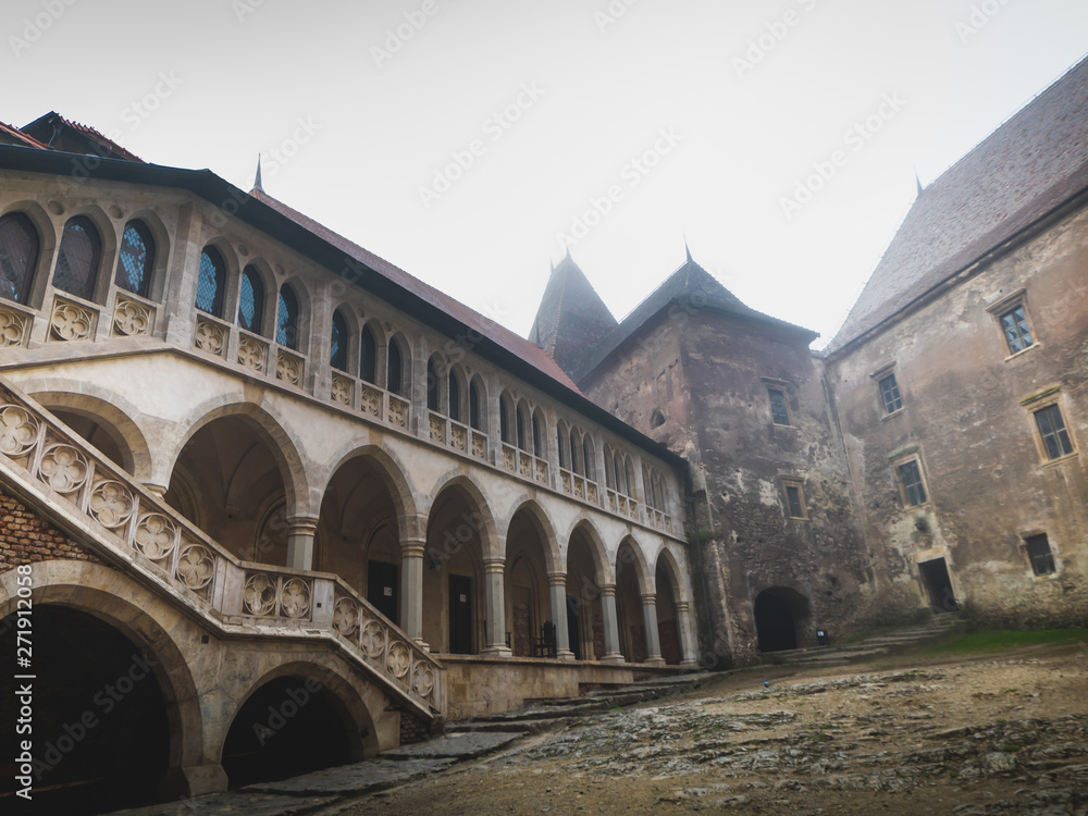 interior and exterior of the Hunedoara castle in Romania in foggy conditions
