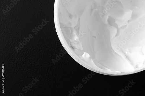 Photography Moisturizer cream for body or face on black background, close-up, selective focu