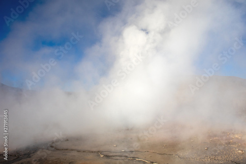 Hot spring at El Tatio Geysers with steaming geysers, hot springs, boiling water all around at sunrise, Chile, South America