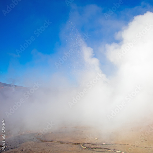 Hot spring at El Tatio Geysers with steaming geysers, hot springs, boiling water all around at sunrise, Chile, South America