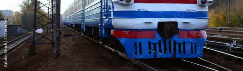 Old soviet electric train with outdated design moving by rail photo