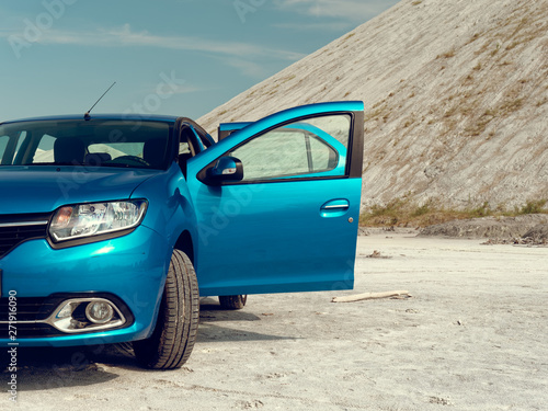 GOMEL, BELARUS Blue car in lifeless desert. photo