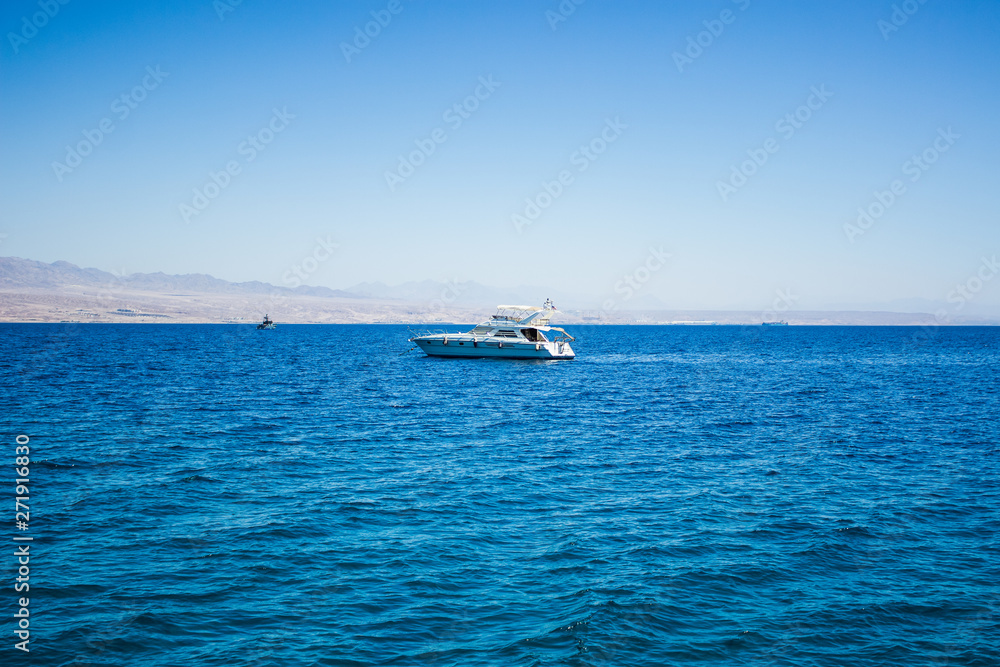 white yacht in the Red sea nature environment surrounded by blue smooth water surface, cruise summer vacation concept 