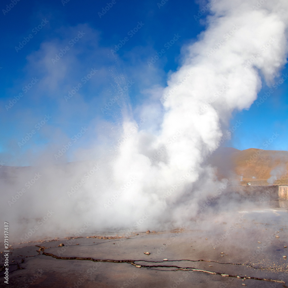 Erupting Hot Geyser Of Steam in El Tatio Geysers field at early morning sunrise, Atacama desert, Chile
