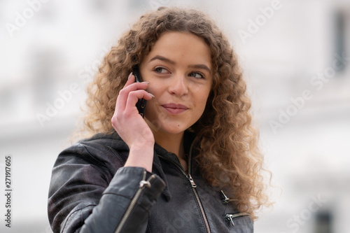 Young woman using her phone outdoors in Rome, Italy