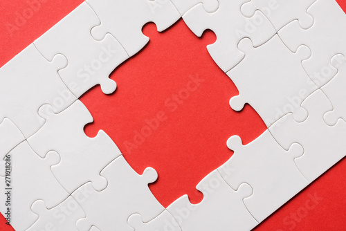 top view of unfinished white jigsaw puzzles isolated on red