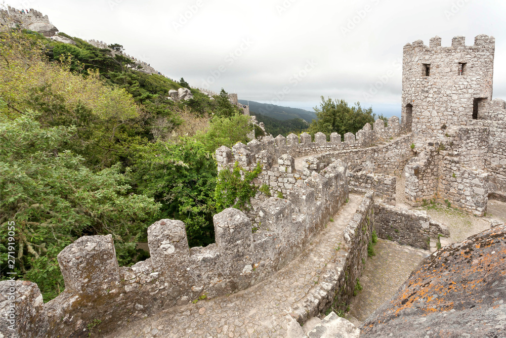 Walls and stone towers of the 8th century The Moorish Castle over town Sintra. Historical landscape in Portugal and a UNESCO world heritage site