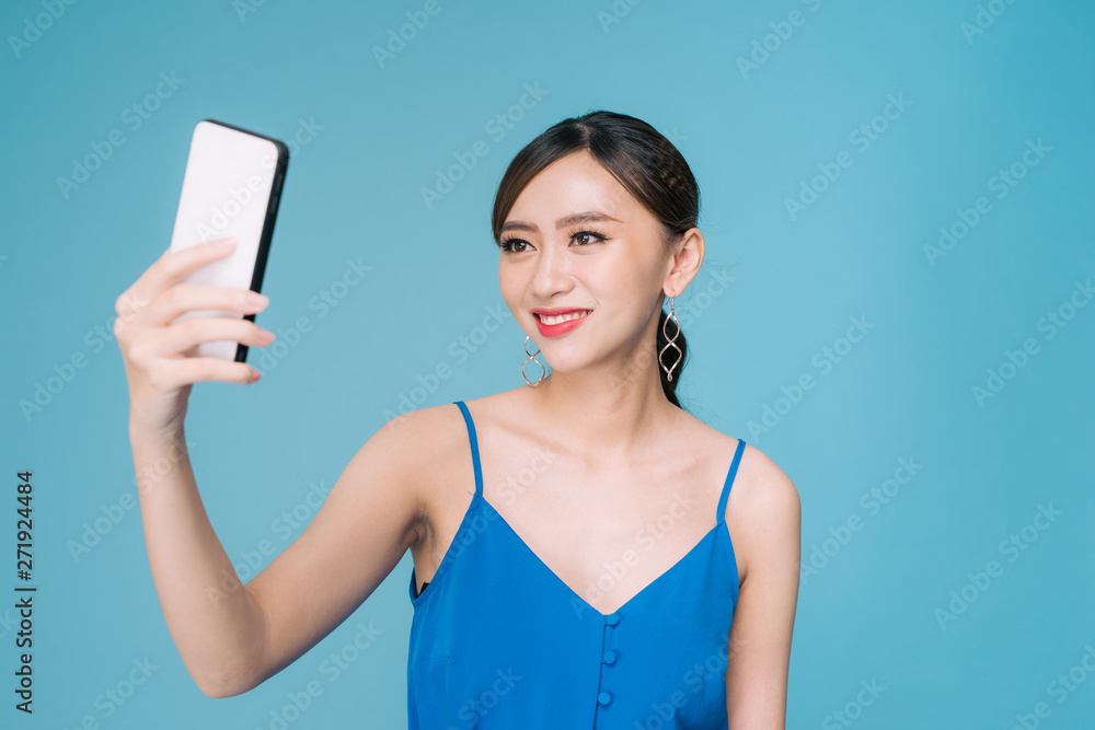 Selfie time. Joyful young women making selfie by her smart phone