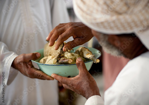 Men Sharing Honey In Sinaw Market, Oman photo