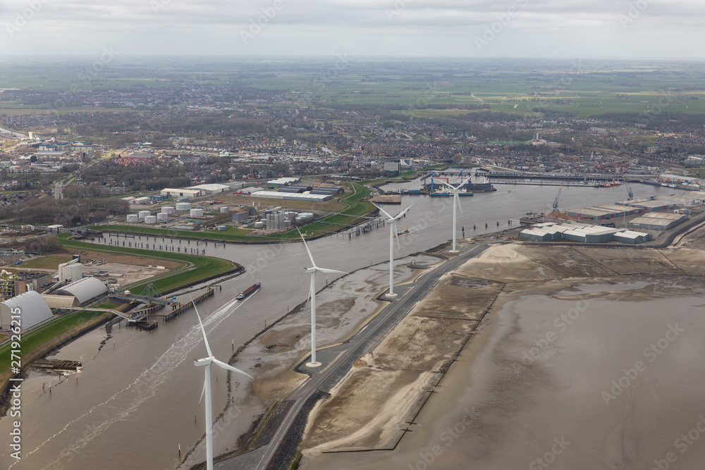 Aerial view Dutch harbor Delfzijl with wind turbines and factories
