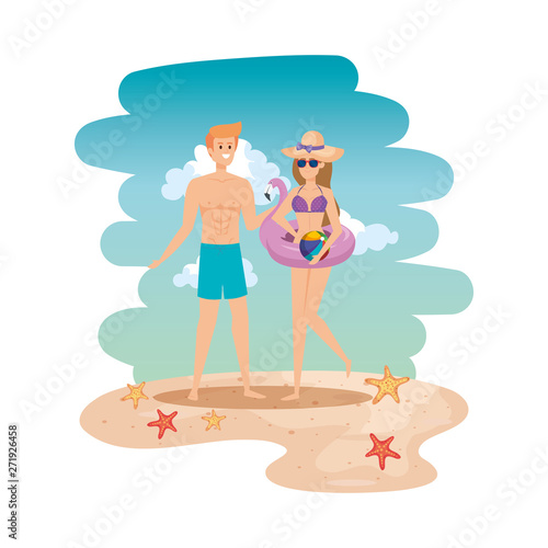 young couple with swimsuit and flemish float on the beach