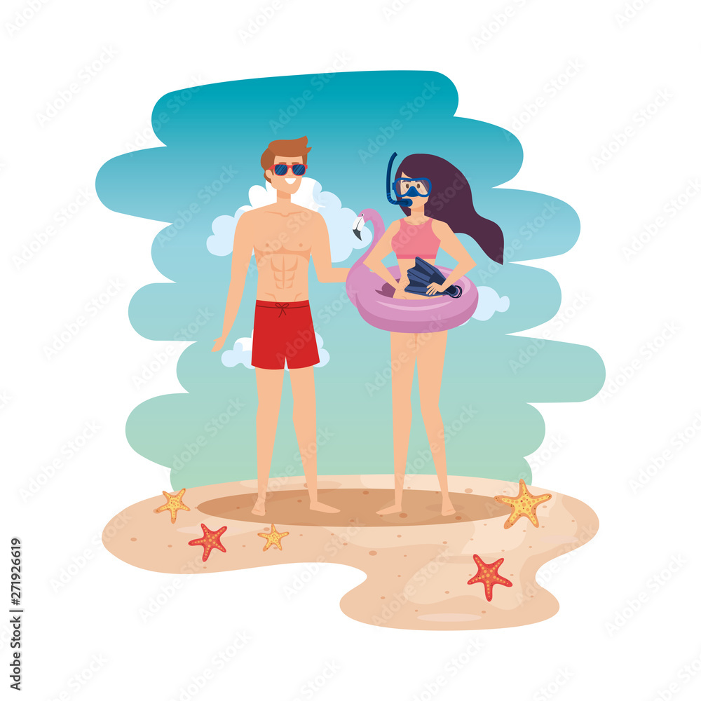 young couple with float and equipment diving on the beach