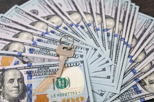 Key to money. Key with US dollars banknotes, for the concept of key to success, earning, safety