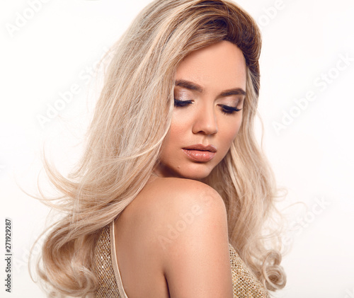 Ombre blond wavy hair. Beauty fashion blonde woman portrait. Beautiful girl model with makeup, long healthy hairstyle posing isolated on studio white background.