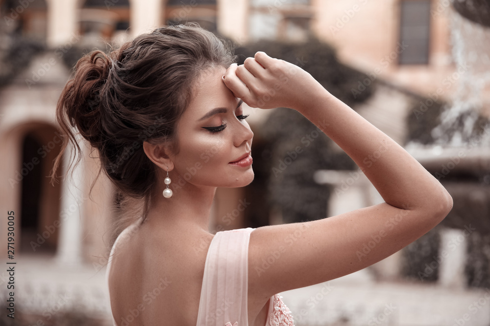 Beautiful bride with pearl earrings jewelry wears pink prom dress. Outdoor  romantic portrait of Attractive brunette woman with makeup and wedding hair  style posing at park. Stock Photo | Adobe Stock
