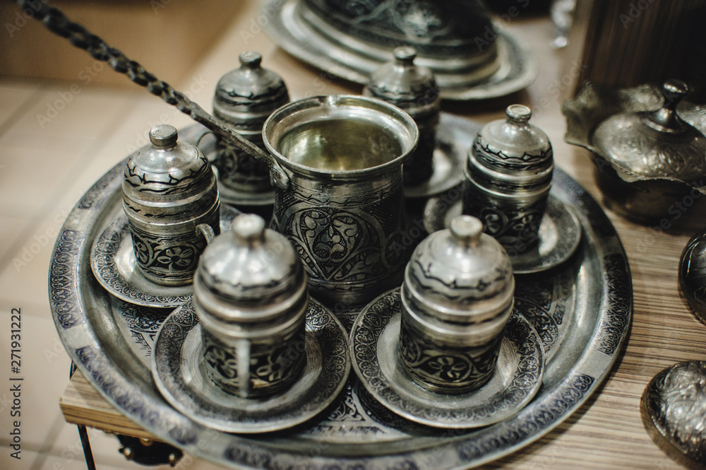 Turk for coffee. Traditional handmade sets. Teapot and cups for coffee and tea. Ancient, Oriental silver metallic set. Turkish national dishes. Dishes in Turkey. Close up