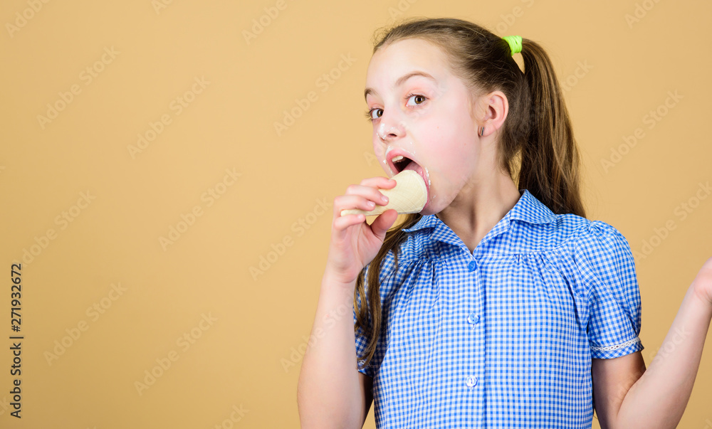Carefree kid enjoy sweet ice cream. International childrens day. Sweet tooth concept. Girl little child eat ice cream cone beige background. Summer is here. Delicious ice cream. Happy childhood Carefree kid enjoy sweet ice cream. International childrens day. Sweet tooth concept. Girl little child eat ice cream cone beige background. Summer is here. Delicious ice cream. Happy childhood