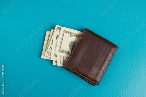 Male wallet with banknotes studio image. Leather wallet with dollar bills.