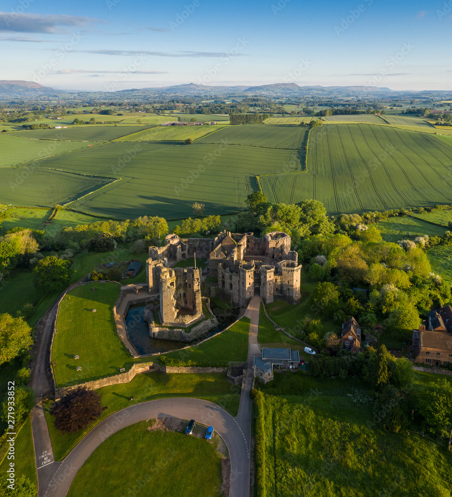 Aerial panoramic view of the ruins of Raglan castle, a late medieval castle located just north of the village of Raglan in the county of Monmouthshire in south east Wales, UK