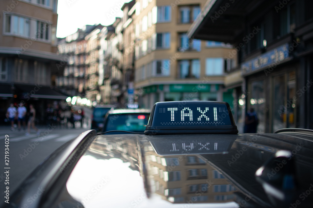 Fototapeta premium Closeup of Black Taxi sign on a late summer day
