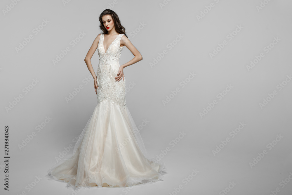 Horizontal view of a beautiful female model with long hair, make up in wendding dress, isolated on a white background. Horizontal view of a beautiful female model with long hair, make up in wendding dress, isolated on a white background.