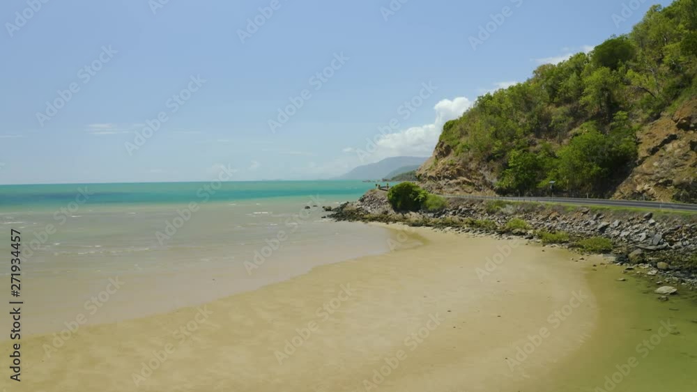 Aerial, low tide, huge sand ocean bed and a road near Cairns in Queensland Australia Aerial, low tide, huge sand ocean bed and a road near Cairns in Queensland Australia