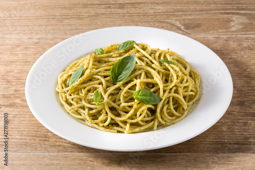 Spaghetti pasta with pesto sauce on wooden table