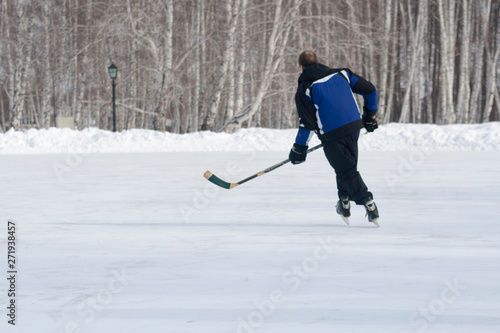 Photography A man with a stick playing ice hockey