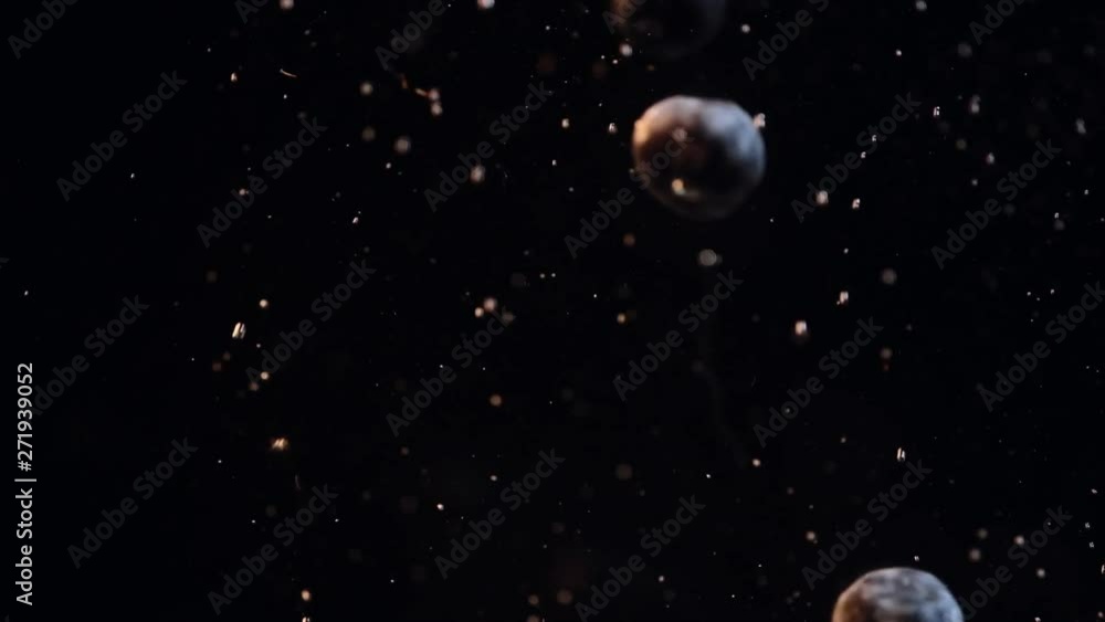 Blueberries falling into water with bubbles against black background. Blueberries falling into water with bubbles against black background.