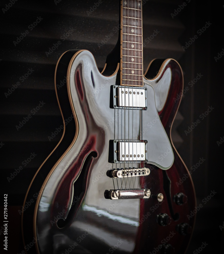 Black electric guitar, vintage style.