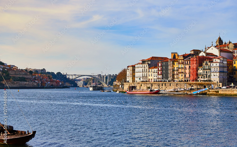 Obraz premium Portugal, Porto old town ribeira aerial promenade view with colorful houses, Douro river and boats.Concept of world travel, sightseeing and tourism