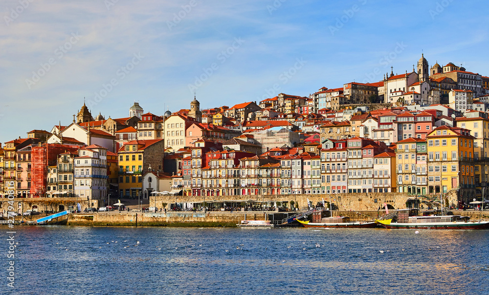Portugal, Porto old town ribeira aerial promenade view with colorful houses, Douro river and boats.Concept of world travel, sightseeing and tourism