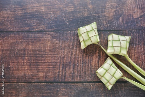 Ketupat (Rice Dumpling) On Wooden Background. Ketupat is a natural rice casing made from young coconut leaves for cooking rice during eid Mubarak, Fitri 